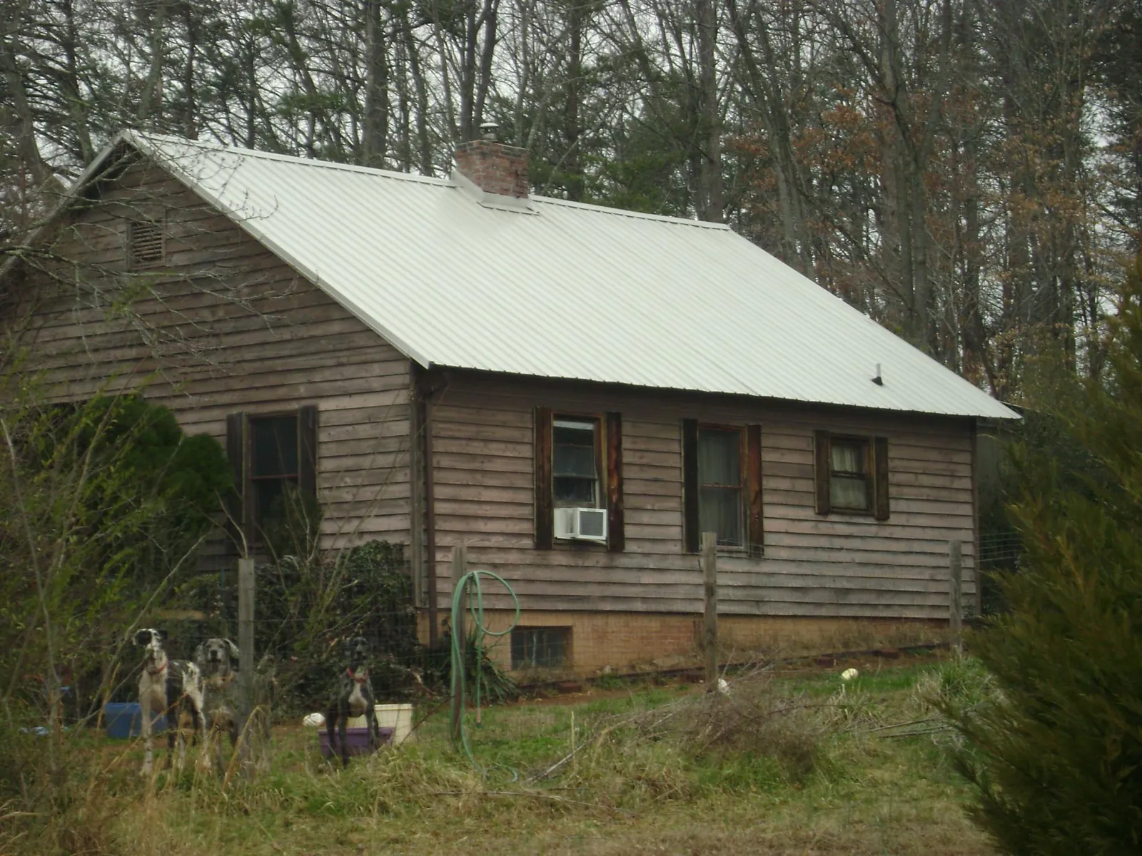 White metal roof on an old wood sided farmhouse, from a Metal Roof Installation job in Perryville